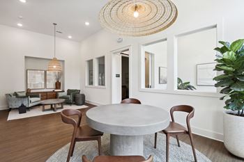 A modern dining room with a round table and chairs